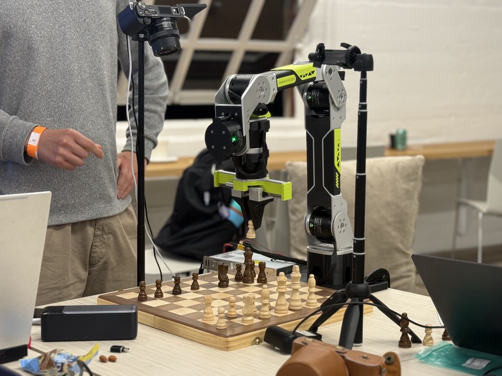 reBot DevArm with overhead camera mounted above a wooden chessboard.